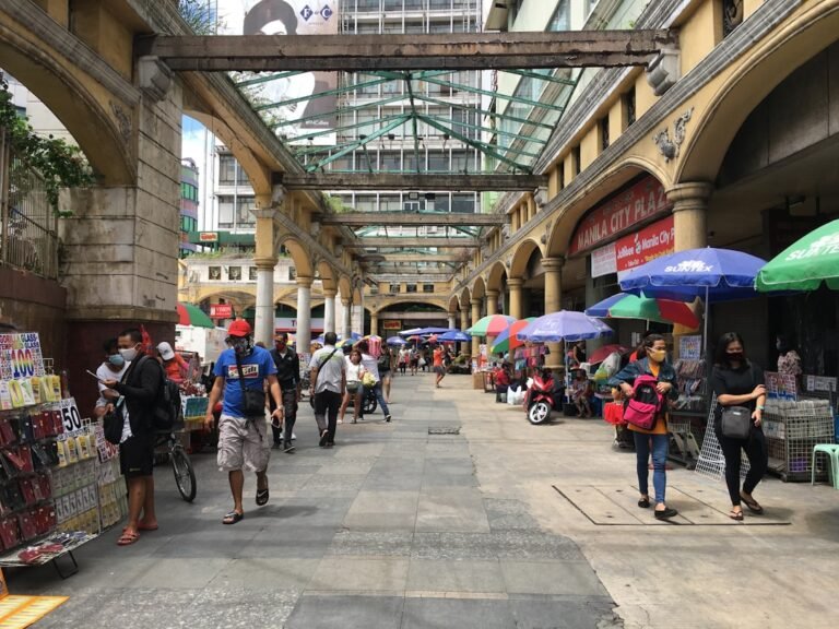 Where to stay in Manila, a busy Manila sidewalk near budget accommodation