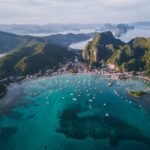 Where to stay in Palawan: aerial view of El Nido town and its beachfront hotels