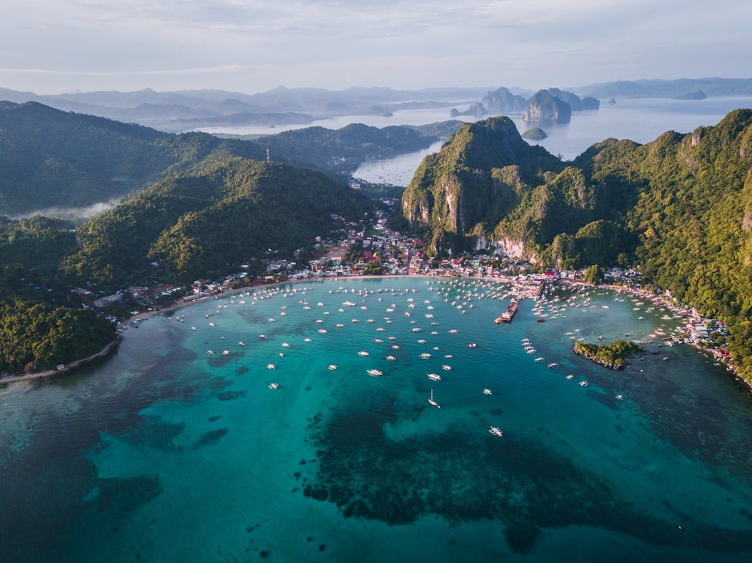 Where to stay in Palawan: aerial view of El Nido town and its beachfront hotels